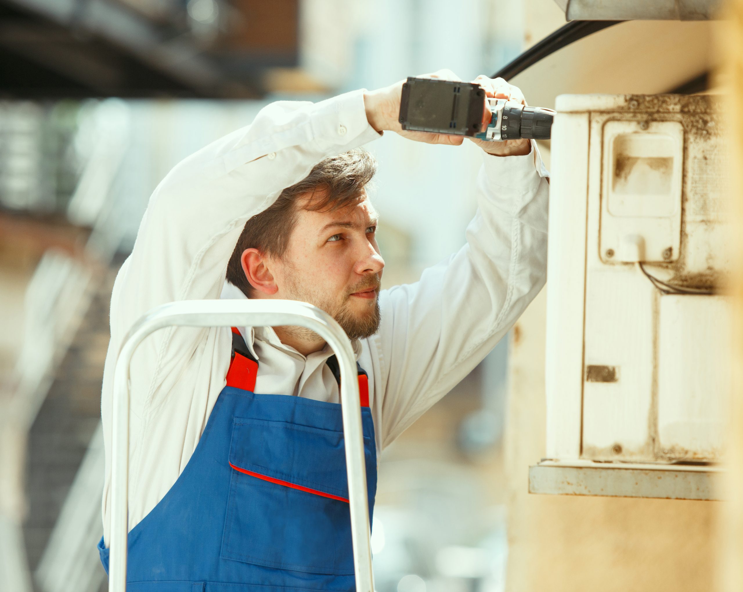 HVAC technician working on a capacitor part for condensing unit